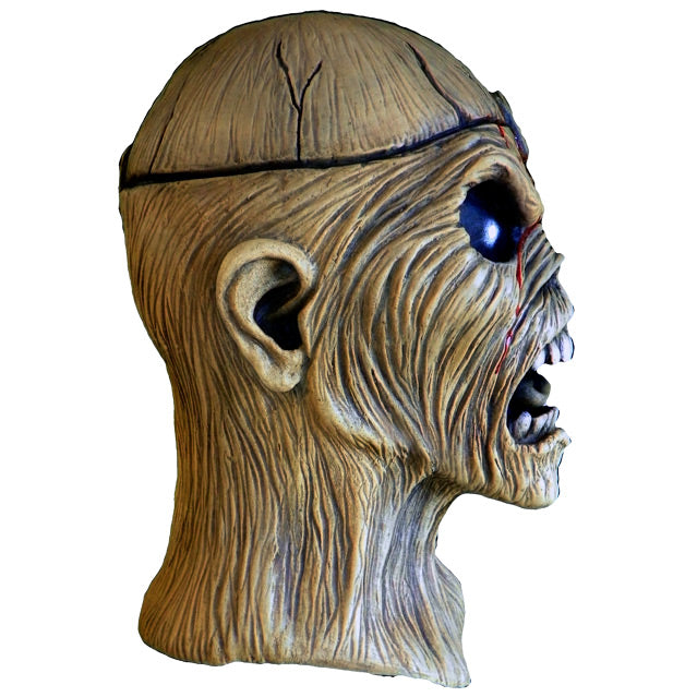 Mask, head and neck, right side view. Iron Maiden Eddie, tan, blood coming from middle of forehead large black eyes, open scowling mouth showing teeth.