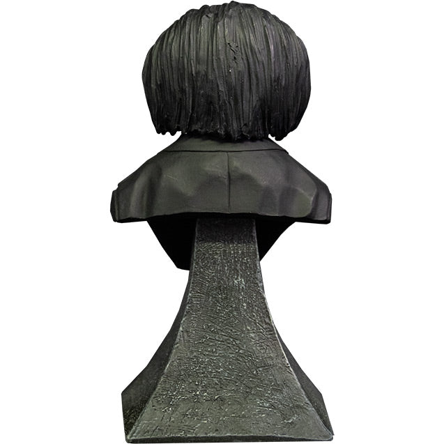Mini bust, back view. Saw Billy Puppet. Head and shoulders. Black hair, black suit coat. Set on gray stone textured base.