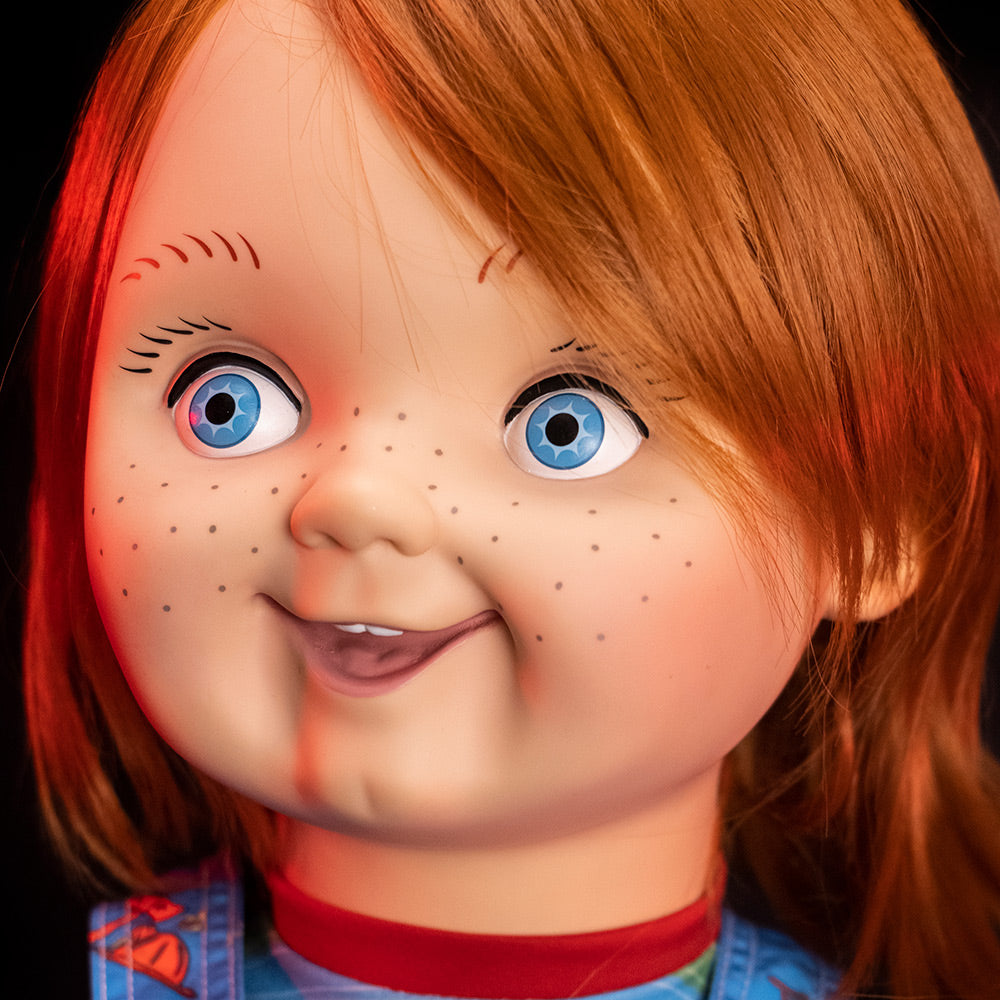 Plush body Good Guy doll, close up of face. Red hair, blue eyes, freckles, cleft chin. 