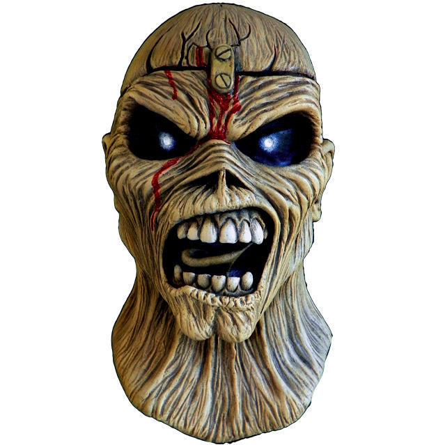 Mask, head and neck, front view. Iron Maiden Eddie, tan, blood coming from middle of forehead large black eyes, open scowling mouth showing teeth.