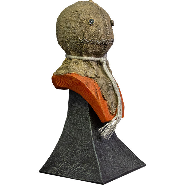 Mini bust. Right view. Trick r' Treat Sam bust, head shoulders and upper chest. Head is a stitched burlap sack, Button eyes, stitched mouth, rope tied around neck, orange shirt. Set on gray stone textured base.