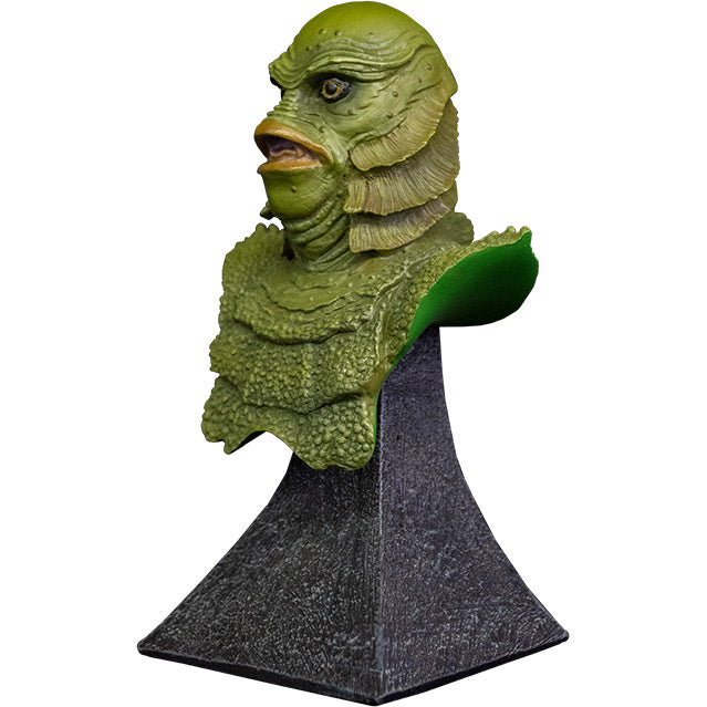 Mini bust, left view. Head, shoulders and upper chest of green scaly fish-man, yellow eyes, large lips, no nose. Set on gray stone textured base.