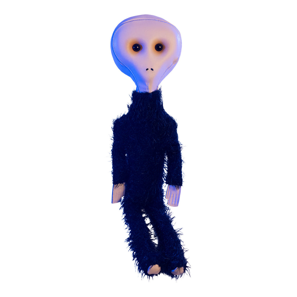Alien Plush, in blue dramatic lighting. Tan head large black eyes, small nostrils, no mouth. Black fur body, bare hands.