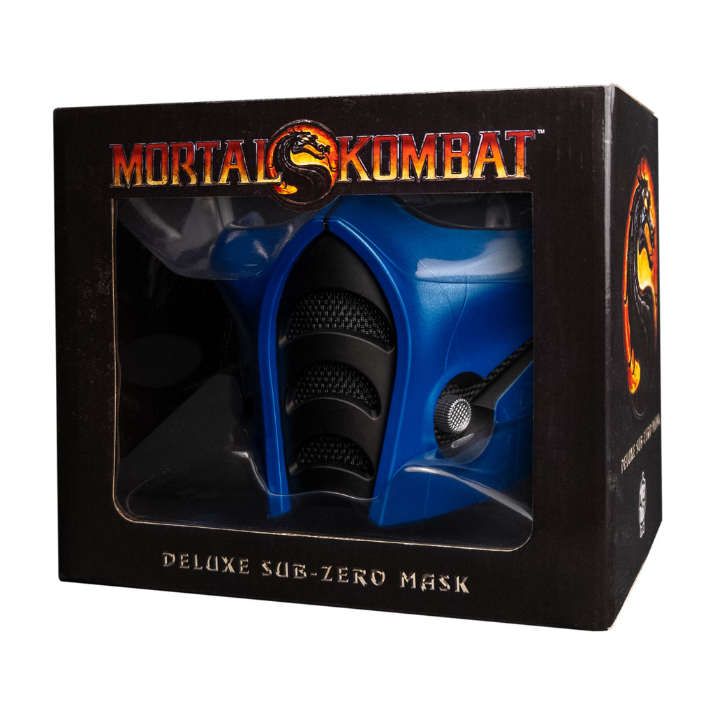 Product packaging, front.  Black window box, showing mask.  Text reads Mortal Kombat, Deluxe Sub-zero Mask.