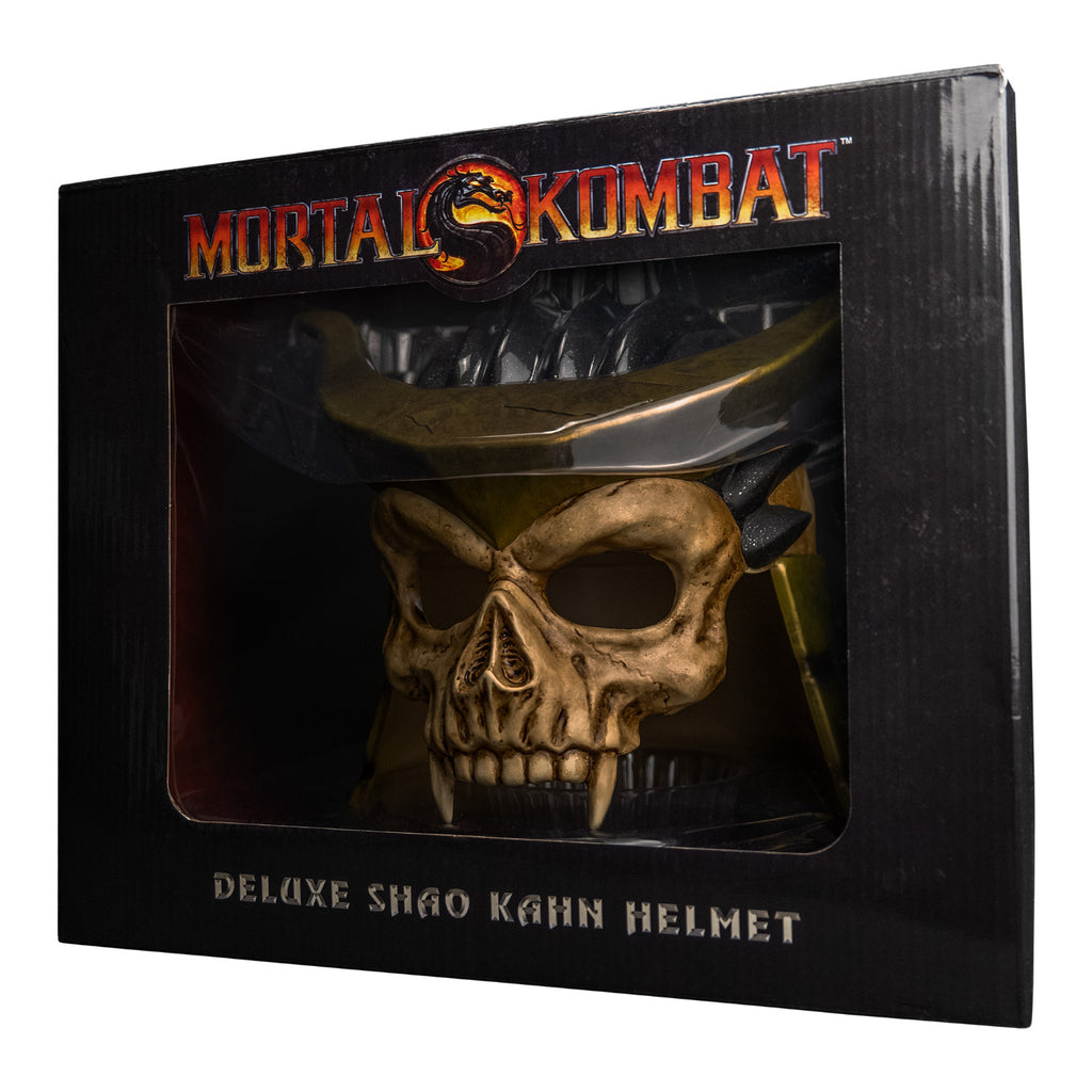 Product packaging, front. Black window box showing helmet. Text reads Mortal Kombat, Deluxe Shao Kahn Helmet. Manufacturing and licensing information.