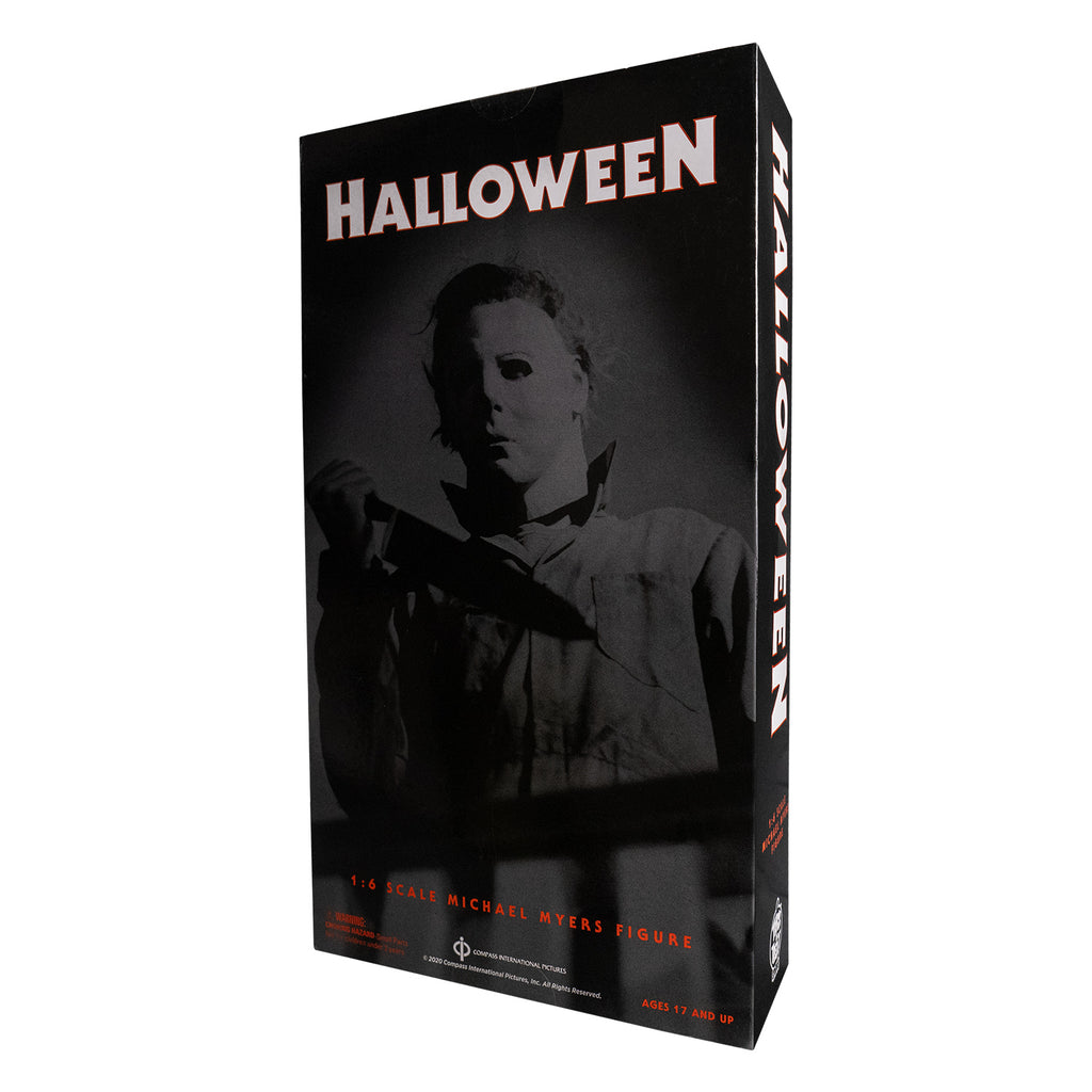 Product packaging back view. Black box. black and whit image of Michael Myers, standing behind banister, holding kitchen knife.  White text reads Halloween, red text reads 1:6 scale Michael Myers Figure. Manufacturer and licensing information.