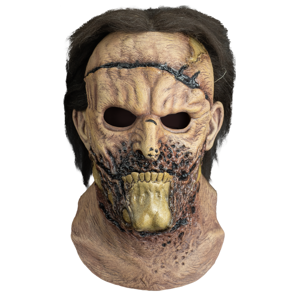 mask, front view, head and neck. brown hair. .  large black gash across forehead. wrinkled and mottled flesh around mouth, center of lower jaw is exposed bone.