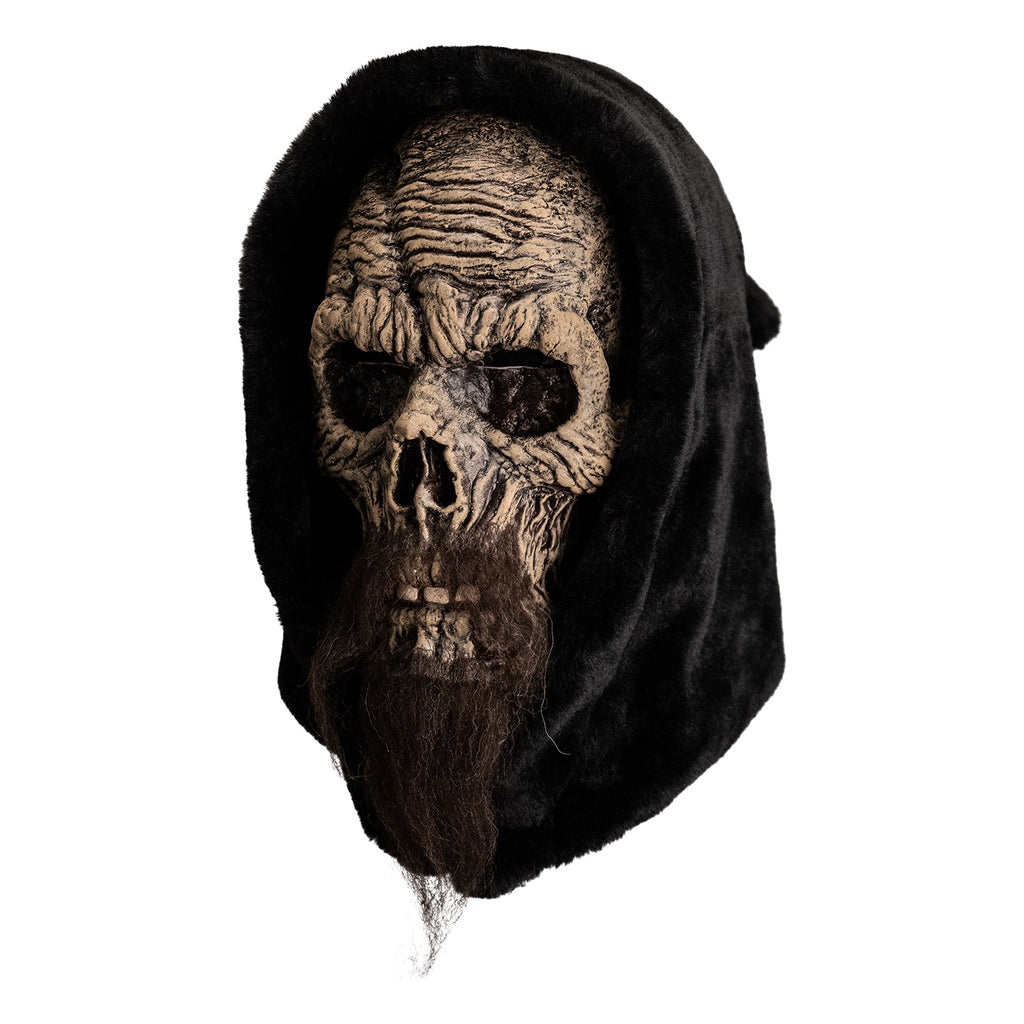 mask, left view. distressed skeletal face with long, dark brown beard, wearing black hood.