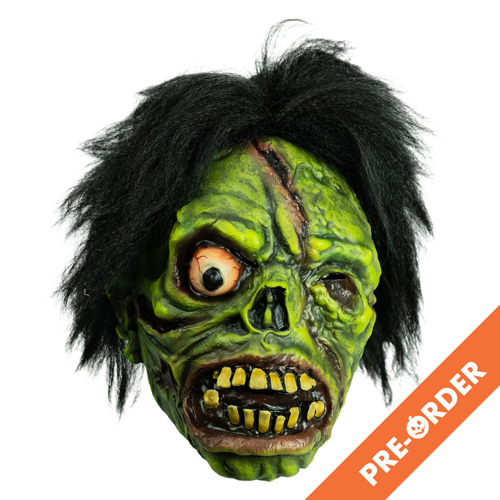 white background, orange diagonal banner at bottom right, white text reads pre-order.  Mask front view. Black bushy hair, Green flesh, wrinkled and wounded. Bulging, bloodshot right eye, missing left eye and nose. Open snarling mouth with yellow crooked teeth.