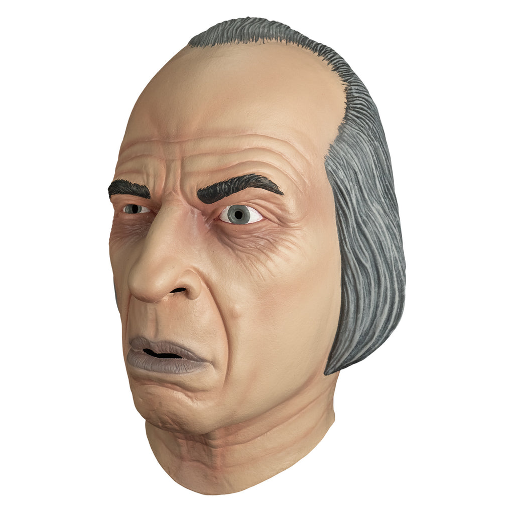 mask, left view. receding hairline, gray hair. wrinkles on forehead and around eyes. Black eyebrows, left eyebrow raised. blue-gray irises, mouth slightly open with grayish lips