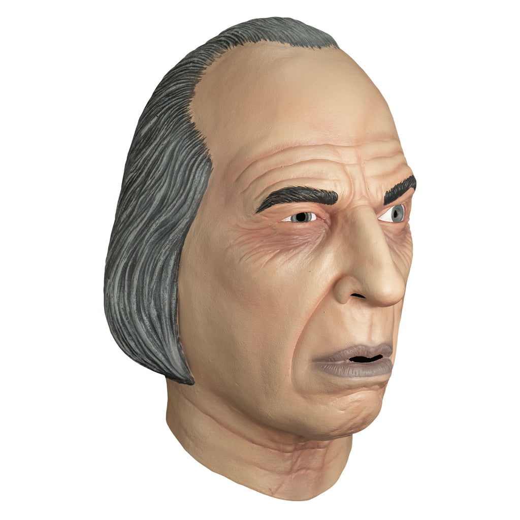 mask, right view. receding hairline, gray hair. wrinkles on forehead and around eyes. Black eyebrows, left eyebrow raised. blue-gray irises, mouth slightly open with grayish lips