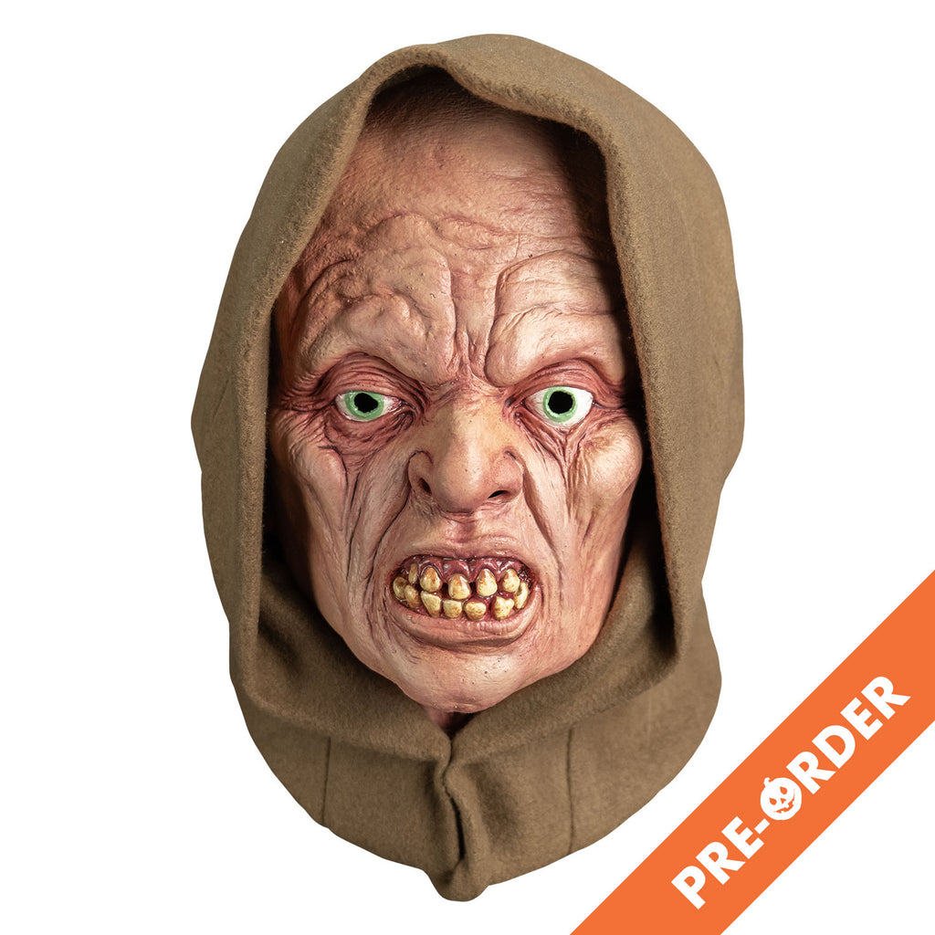 white background, orange diagonal banner at bottom right, white text reads pre-order.  mask, front view. wearing tan hood. pink wrinkled flesh. no eyebrows, pale blue irises, lips open showing crooked yellowed teeth.