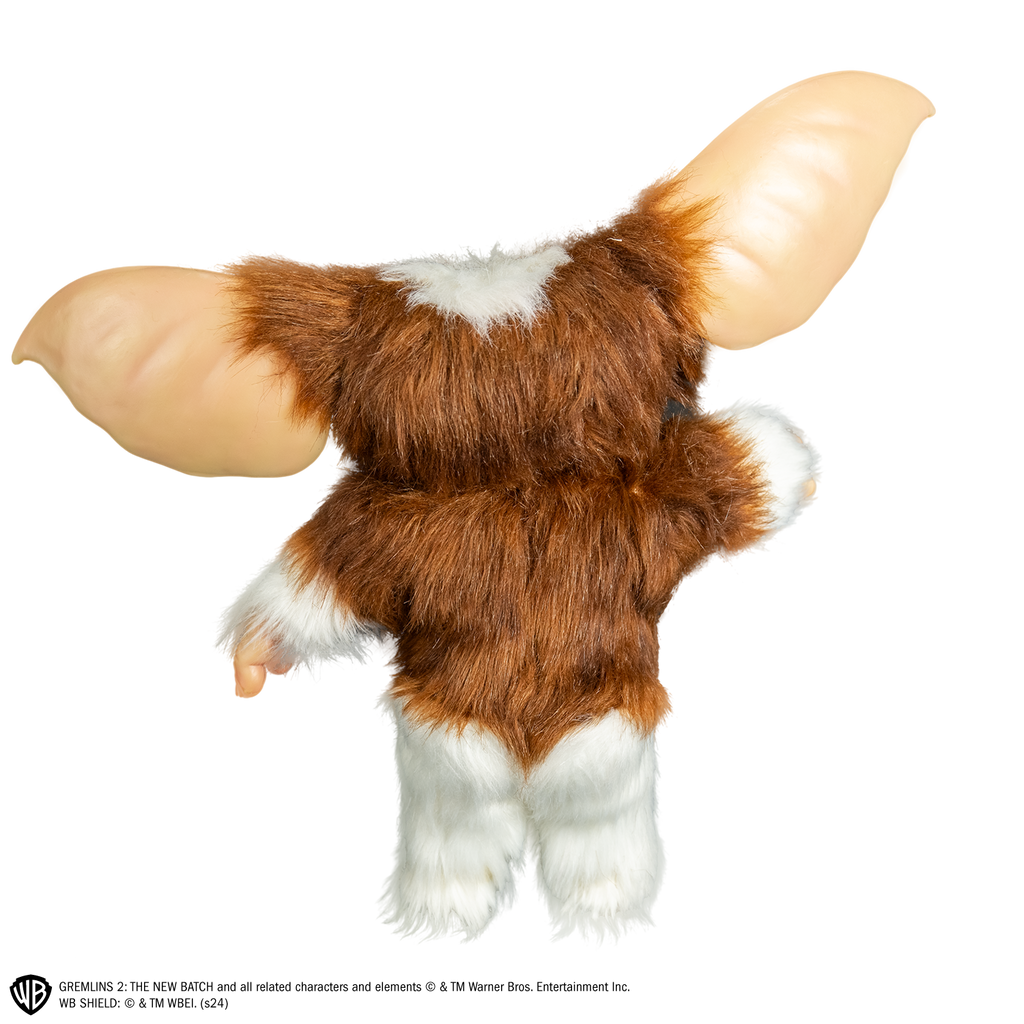 Gizmo mogwai prop, back view, full body, brown and white fur, large pointed tan ears. Hairless hands and feet.