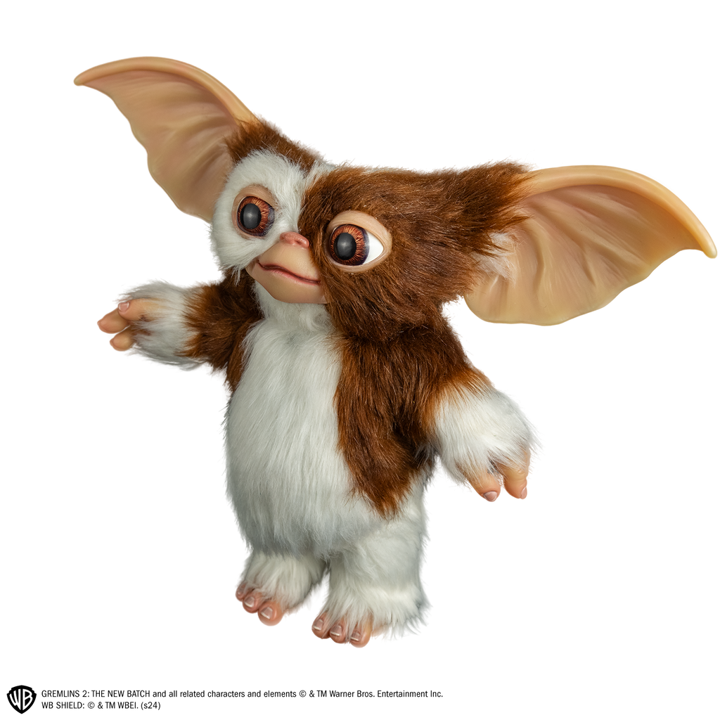 Gizmo mogwai prop, left side view, full body, brown and white fur large brown eyes, large pointed tan ears. Hairless hands and feet.