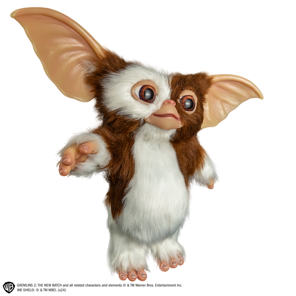 Gizmo mogwai prop, right side view, full body, brown and white fur large brown eyes, large pointed tan ears.  Hairless hands and feet.