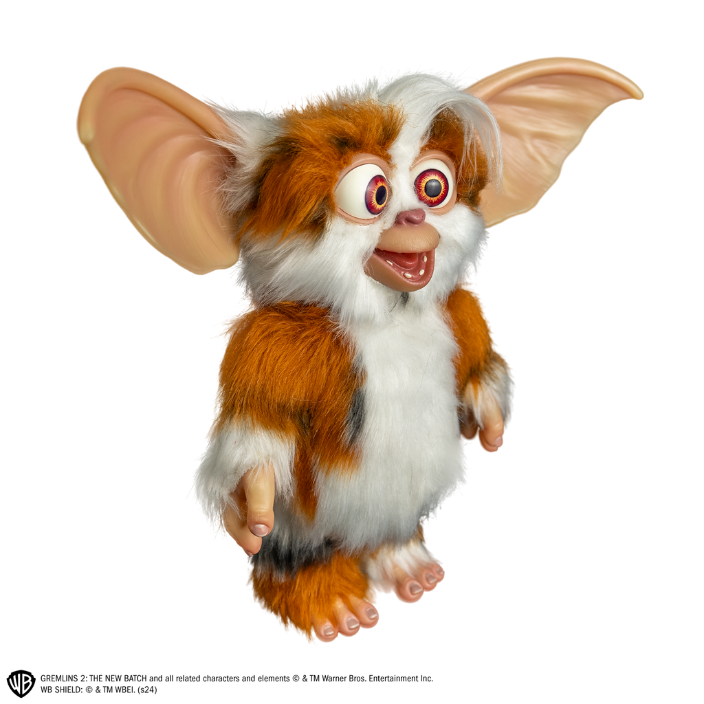 Gremlins 2 prop - Mogwai Daffy, full body, standing, right side view, brown and white with some black fur, large crossed eyes, mouth open in a smile, large pointed tan ears. Hairless hands and feet.