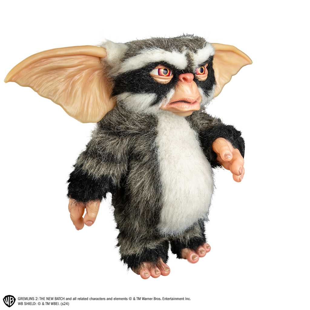 George mogwai prop, right view, full body, black, gray and white fur. angry face, large brown eyes, large pointed tan ears.  Hairless hands and feet. 