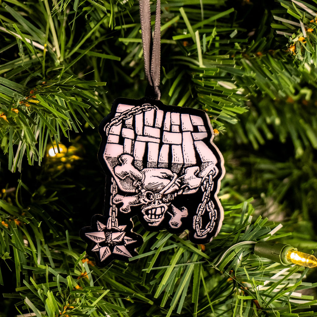 GWAR metal ornament hung on christmas tree.  Black and white illustration, block text reads GWAR above skull and crossbones with chain and spiked ball.