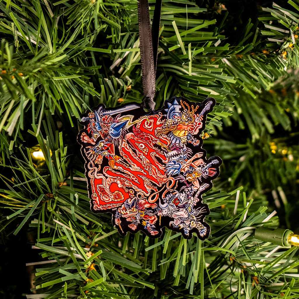 GWAR metal ornament hung on christmas tree.  Multi-colored illustration.  Red text reads GWAR