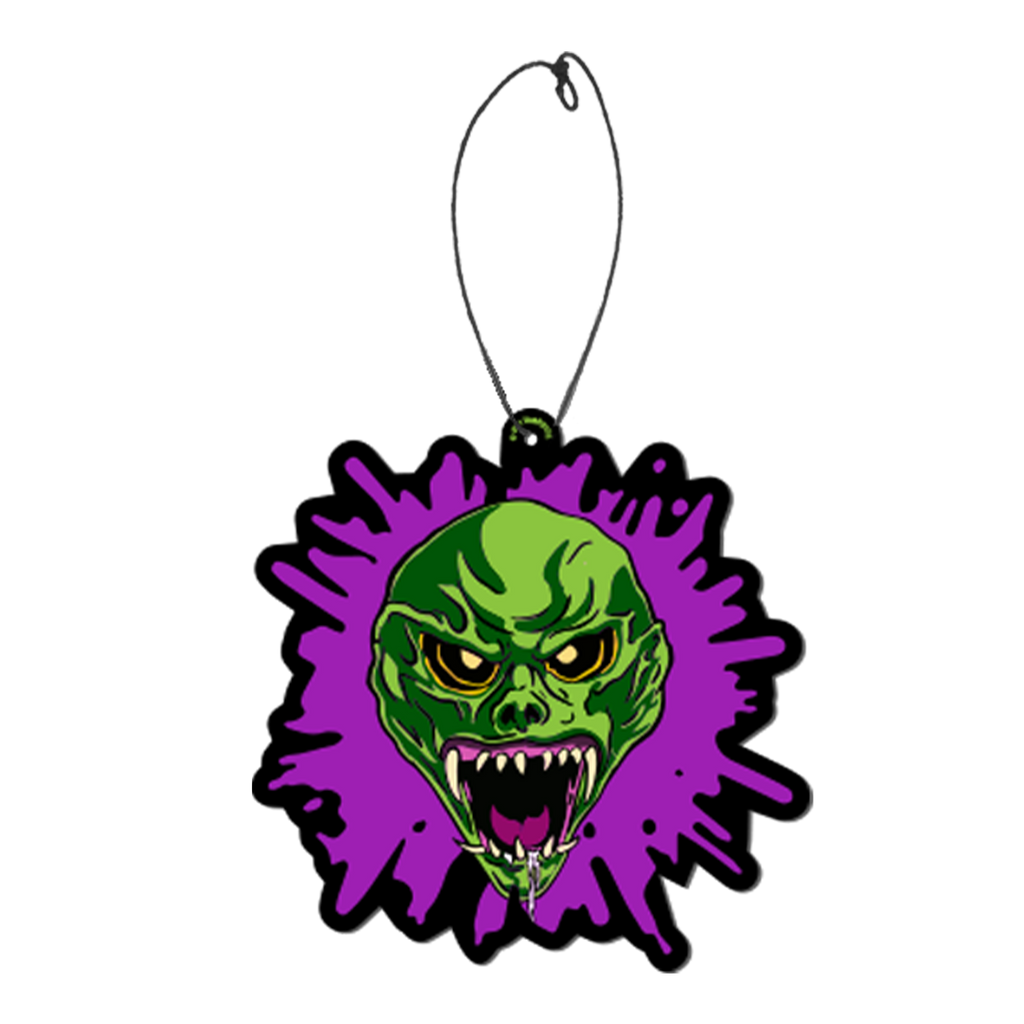 air freshener, purple splatter background, Bright green skin, no hair. Angry face with large ears, black eyes, large snarling mouth with sharp white teeth, pink tongue and gums. white drool on bottom jaw and chin.