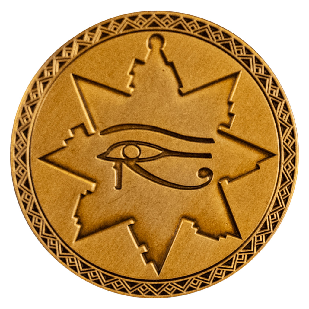 enamel pin. Golden circle, geometric triangle design border around 8 pointed star key shape with eye of Horus in center