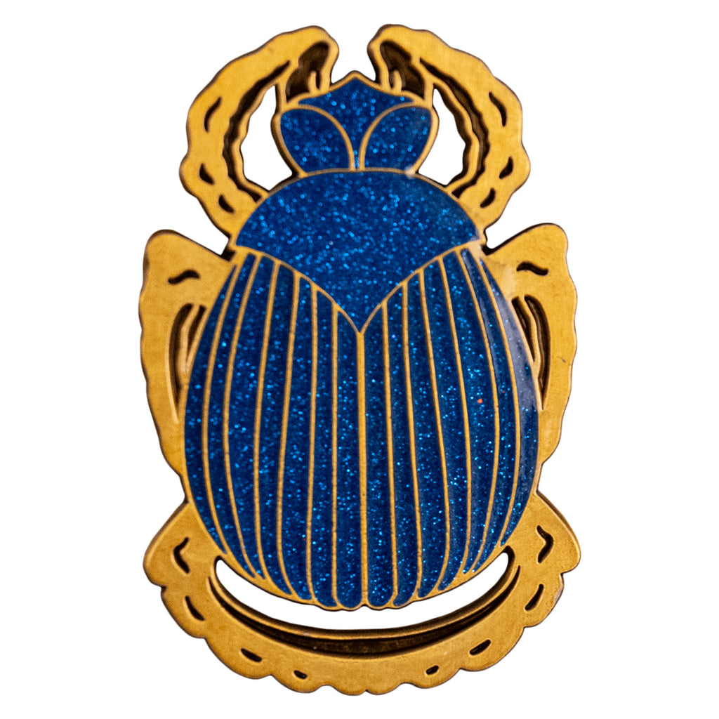 enamel pin.  Scarab beetle, blue body with gold detail and legs