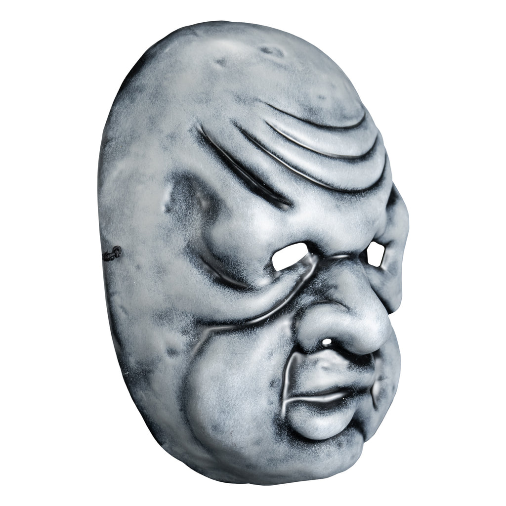 Mask, right view. Black and white toned face mask. Bald, wrinkles on forehead, no eyebrows, bags under small eyes, short fat nose, heavy jowls, mouth with misshapen lower lip.