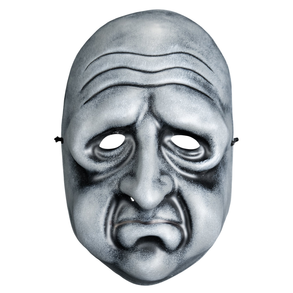 Mask, front view. Black and white toned face mask. Bald, wrinkles on forehead, no eyebrows, bags under eyes, long nose, round cheeks and chin, mouth in a frown with prominent lower lip .