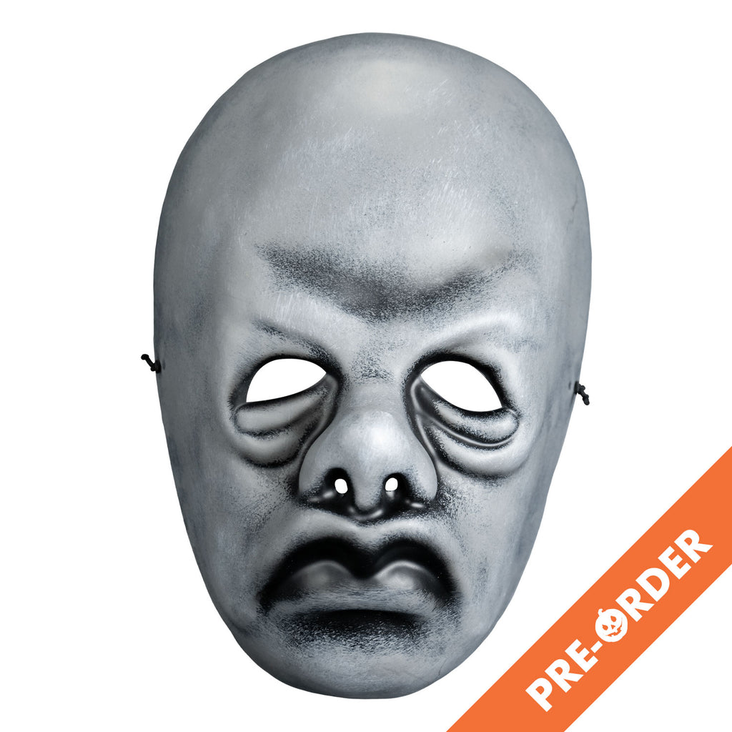 White background, orange diagonal banner at bottom right, white text reads pre-order. Mask, front view. Black and white toned face mask. Bald, no eyebrows, bags under eyes, pug nose, mouth in a frown with prominent lips.