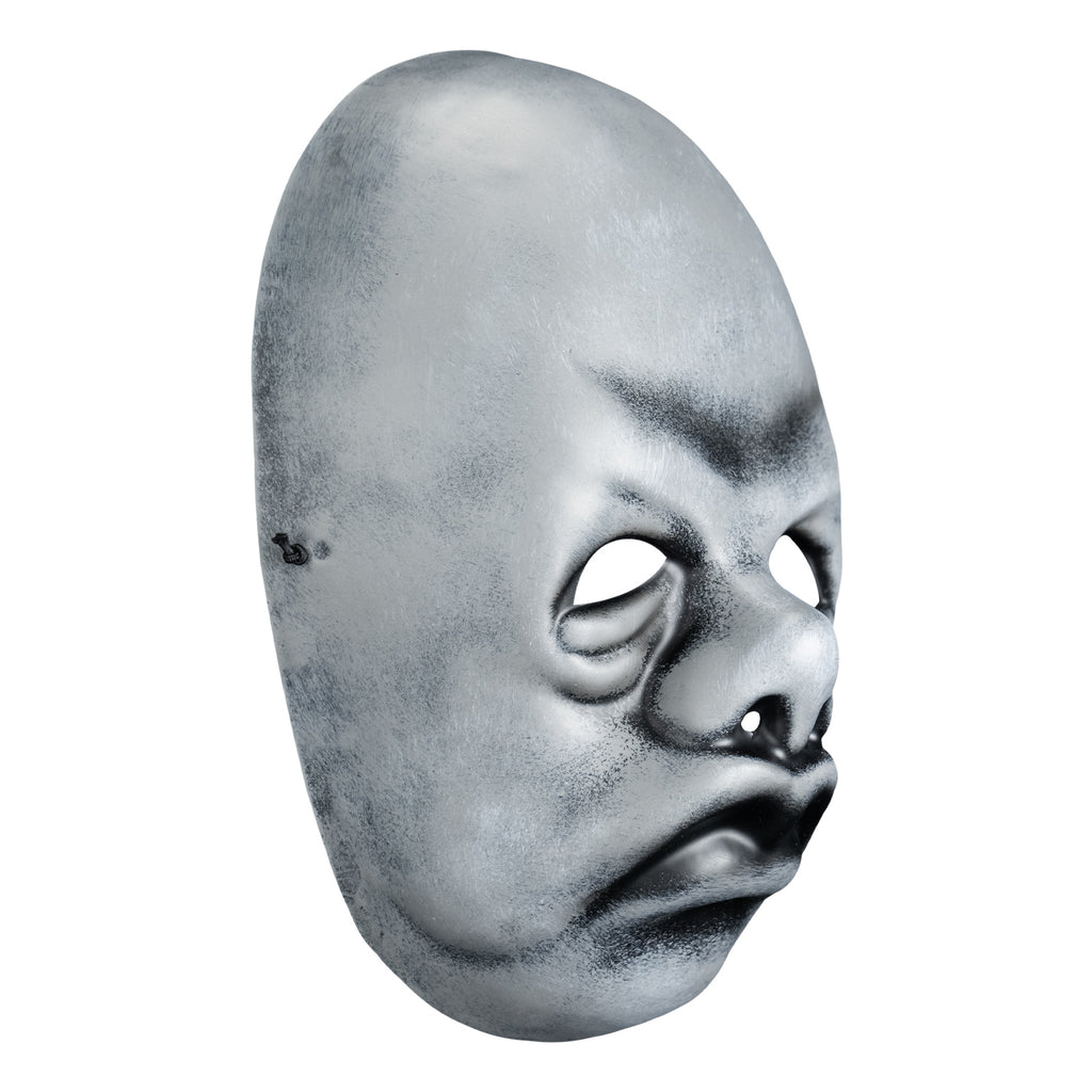 Mask, right view. Black and white toned face mask. Bald, no eyebrows, bags under eyes, pug nose, mouth in a frown with prominent lips.