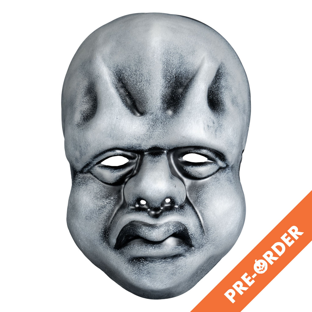 White background, orange diagonal banner at bottom right, white text reads pre-order. Mask, front view. Black and white toned face mask. Bald, ridges on forehead, no eyebrows, bags under small eyes, short fat nose, heavy cheeks and jowls, mouth with prominent frowning lips.