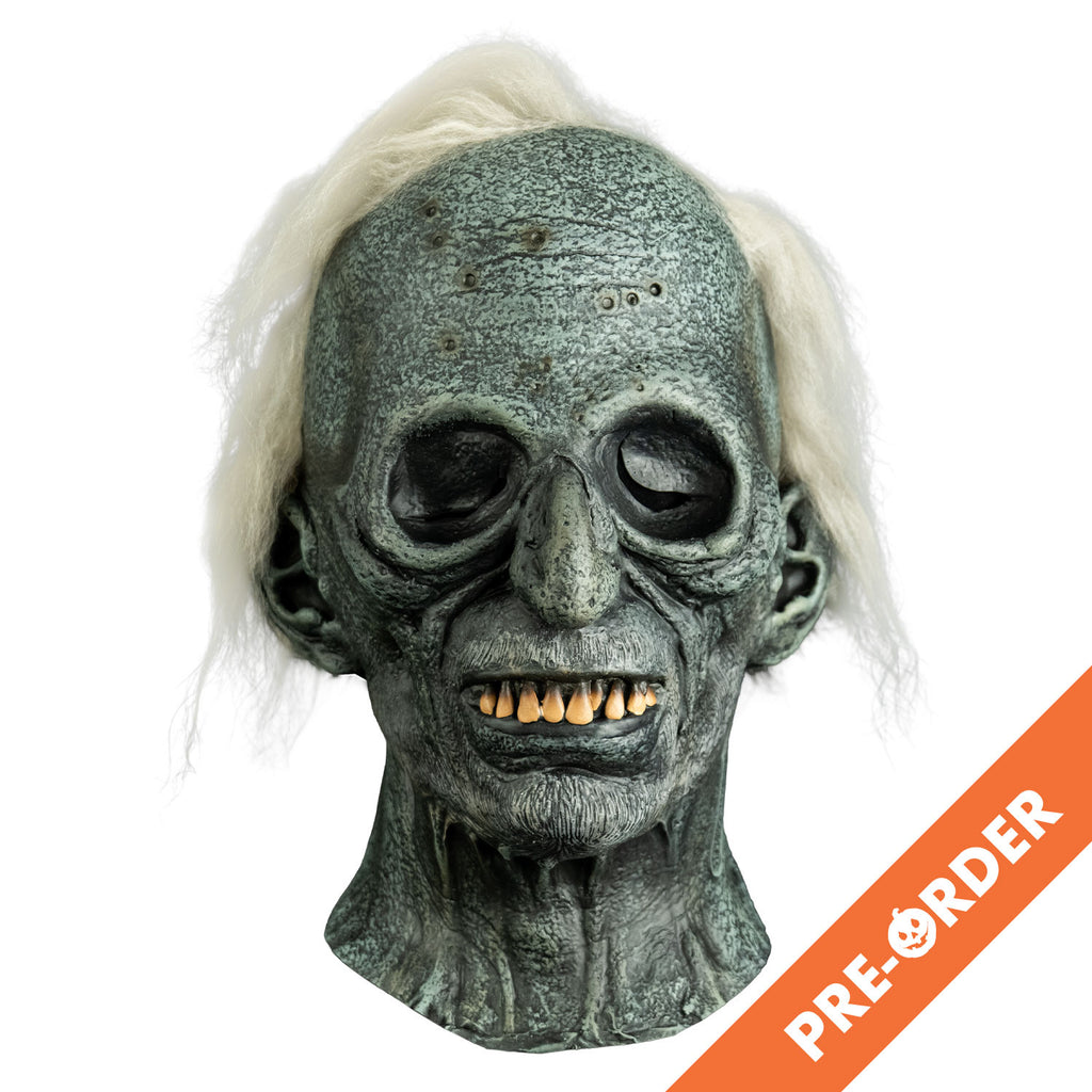 white background, orange diagonal banner at bottom right, white text reads pre-order. mask, front view, head and neck. stringy white hair, gray wrinkled and distressed skin, empty eye sockets, thin lips, yellowed top teeth showing.