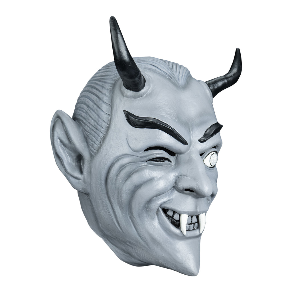 Mask, right view. Black and white toned. Gray slicked-back hair, black horns on forehead, Black eyebrows, dark slightly closed right eye, left eye wide open, smiling mouth, two white fangs.