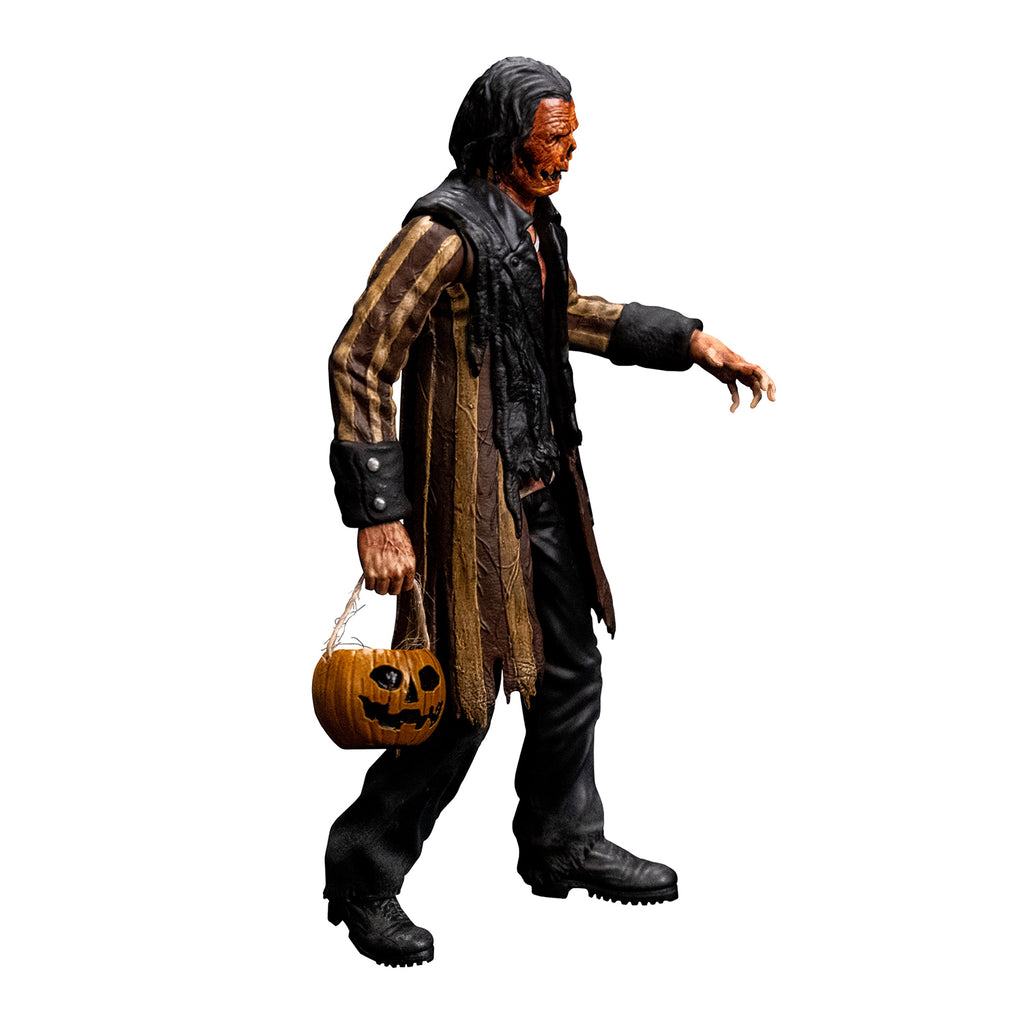 Jacob Atkins figure right side view, man with gory orange Jack O' Lantern-like face, dark slicked back hair. Wearing a bloodstained white shirt, brown and tan striped tattered coat with black cuffs and collar, black pants, black shoes. holding pumpkin candy pail in right hand.
