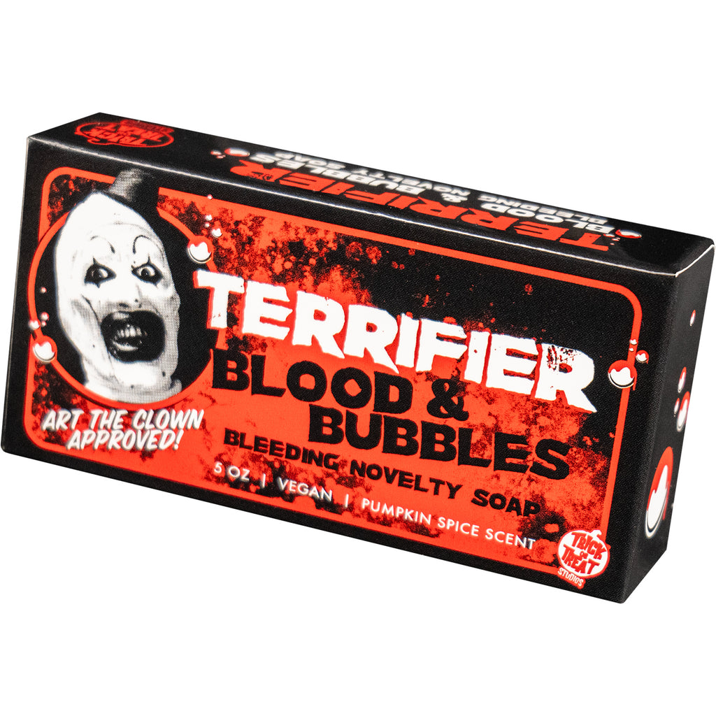 Terrifier soap packaging. Black red and white box. Illustrated white bubbles with dripping red blood. Black and white illustration of Art the clown head. White text reads Terrifier, Art the clown approved, 5 ounce, vegan, pumpkin spice scent. Black text reads Blood & Bubbles, Bleeding novelty soap. Red and white Trick or Treat Studios logo bottom right.