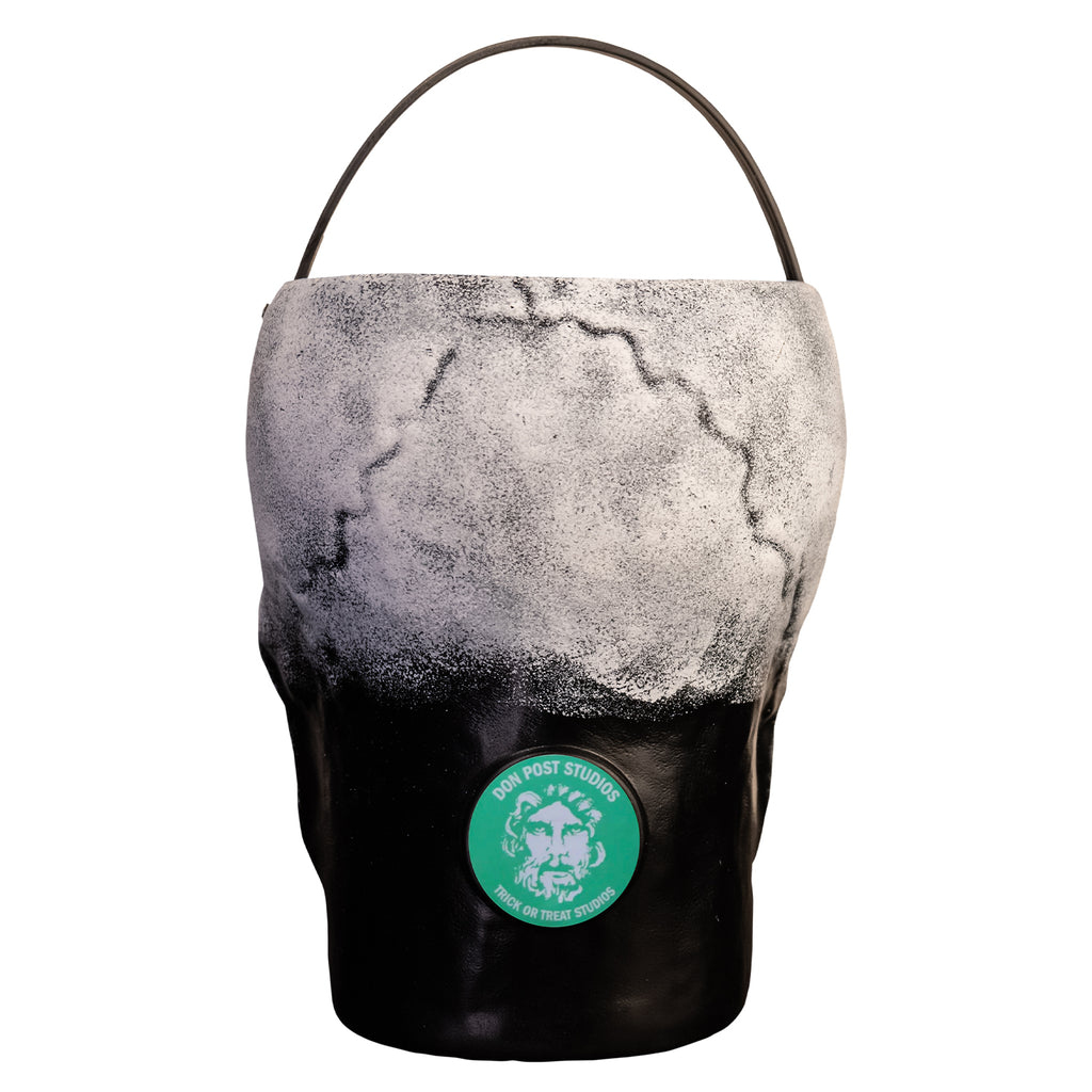 Back view, skull candy pail. white and gray back of skull, black neck area. Light green-blue circle near the bottom in the center with white illustration of face, white text reads Don Post Studios, Trick or treat studios.