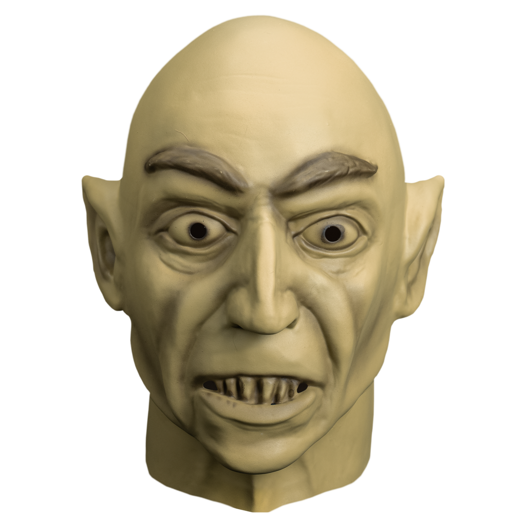 Mask, front view.  head and neck. Bald, large close-set eyebrows, large pointed ears.  wide open eyes. mouth slightly open showing lowere teeth