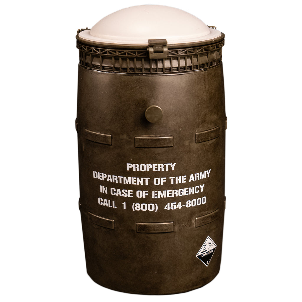 Black barrel with white lid, white text reads property of the army in case of emergency call 1 800 454-8000. 