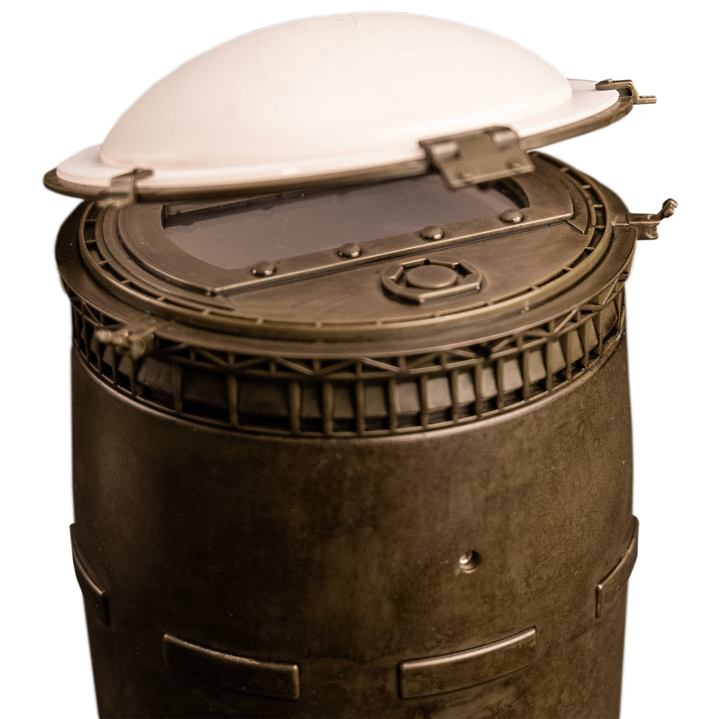 Closeup view of top of barrel.  showing white lid, latches and window under lid