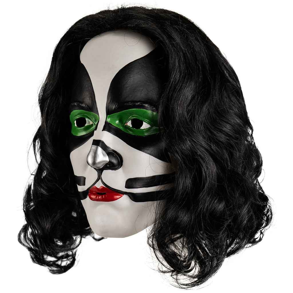 Kiss Catman plastic mask left view. Long black curly hair, white face, green around both eyes surrounded with black painted shapes from the edges of the forehead to the cheekbones, black and silver painted nose, black whisker-like lines next to mouth. bright red lipstick