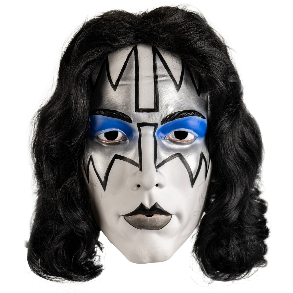 Kiss Spaceman plastic mask front view. Long black hair, white face, Black eyebrows, blue eyeshadow on eyelids, surrounded with silver painted angular shapes outlined in black from the edges of the forehead to the cheekbones, black and gray painted lips.