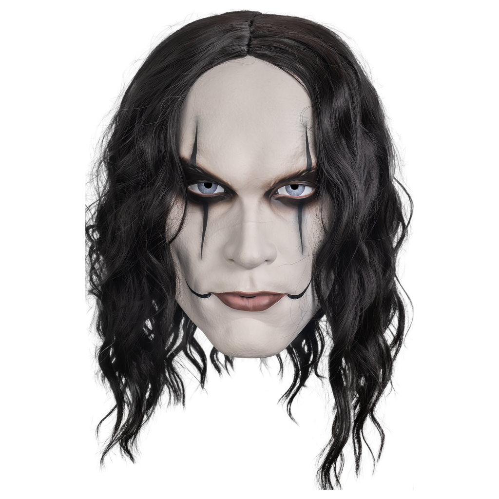 plastic mask, front view. long black wavy hair. white skin, blue eyes, black make-up around eyes, lines drawn down and up from the eyelids.  Pink closed lips with black lines drawn up from the corners of the mouth across cheeks 