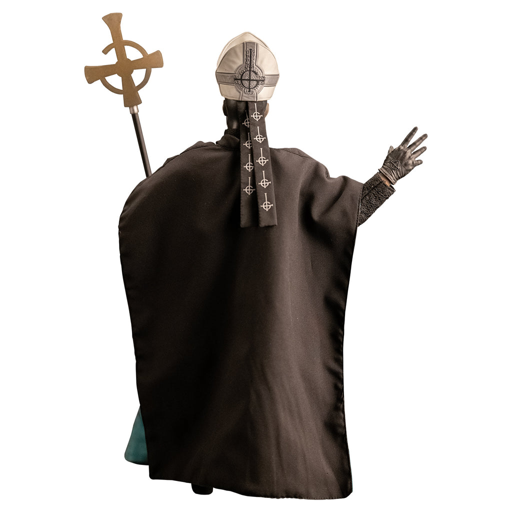 Back view. White background. Figure and accessories.  wearing black and silver, tall hat adorned with black inverted cross with semi circle that looks like a G, black sashes on back. wearing black floor-length robe green on the inside.  black gloves and black boots. Holding black staff topped with inverted gold cross.