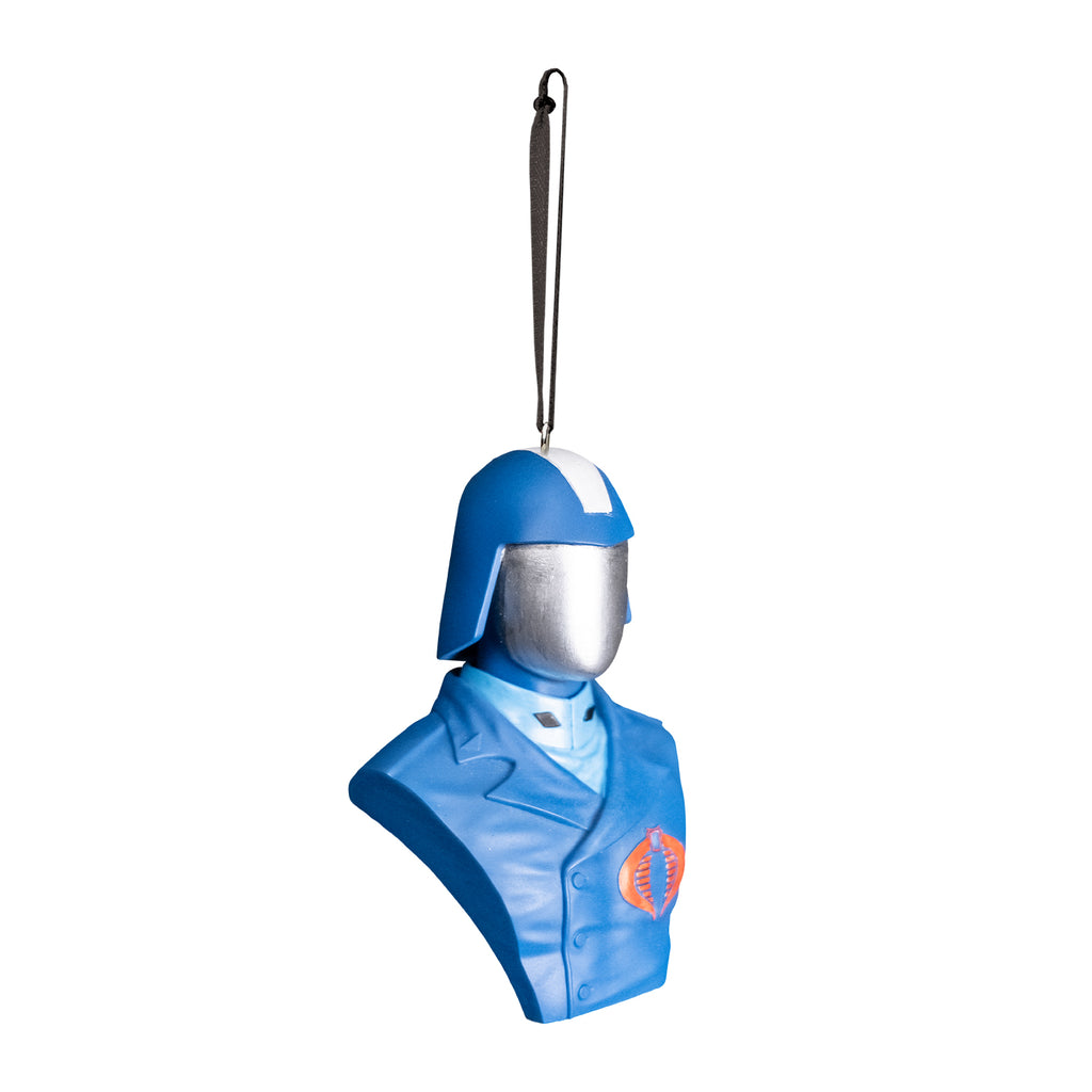 ornament, right view. Bust of Cobra Commander, head shoulders and chest. Wearing blue helmet with wide silver stripe in the center, silver face shield. blue asymetrical buttoned uniform jacket with red cobra emblem on left breast, light blue high-collared shirt underneath. Black cord at top for hanging.