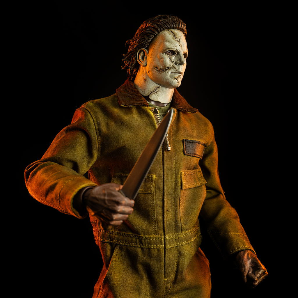 close up, slight right view, above hips. Dramatic lighting. Michael Myers 1:6 scale action figure. Wearing Halloween 2007 mask, tan coveralls. holding kitchen knife in right hand raised to the chest, left hand in fist position at waist.