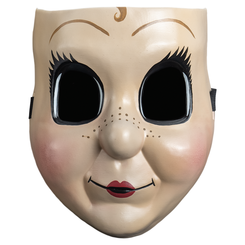 Plastic face mask, front view.  Dollface, Small light brown curly painted in the center of the forehead, large empty black eyes with spiky eyelashes. Thin brown eyebrows. Freckles on nose and cheeks, smiling mouth with small red lips. Plump pink cheeks.