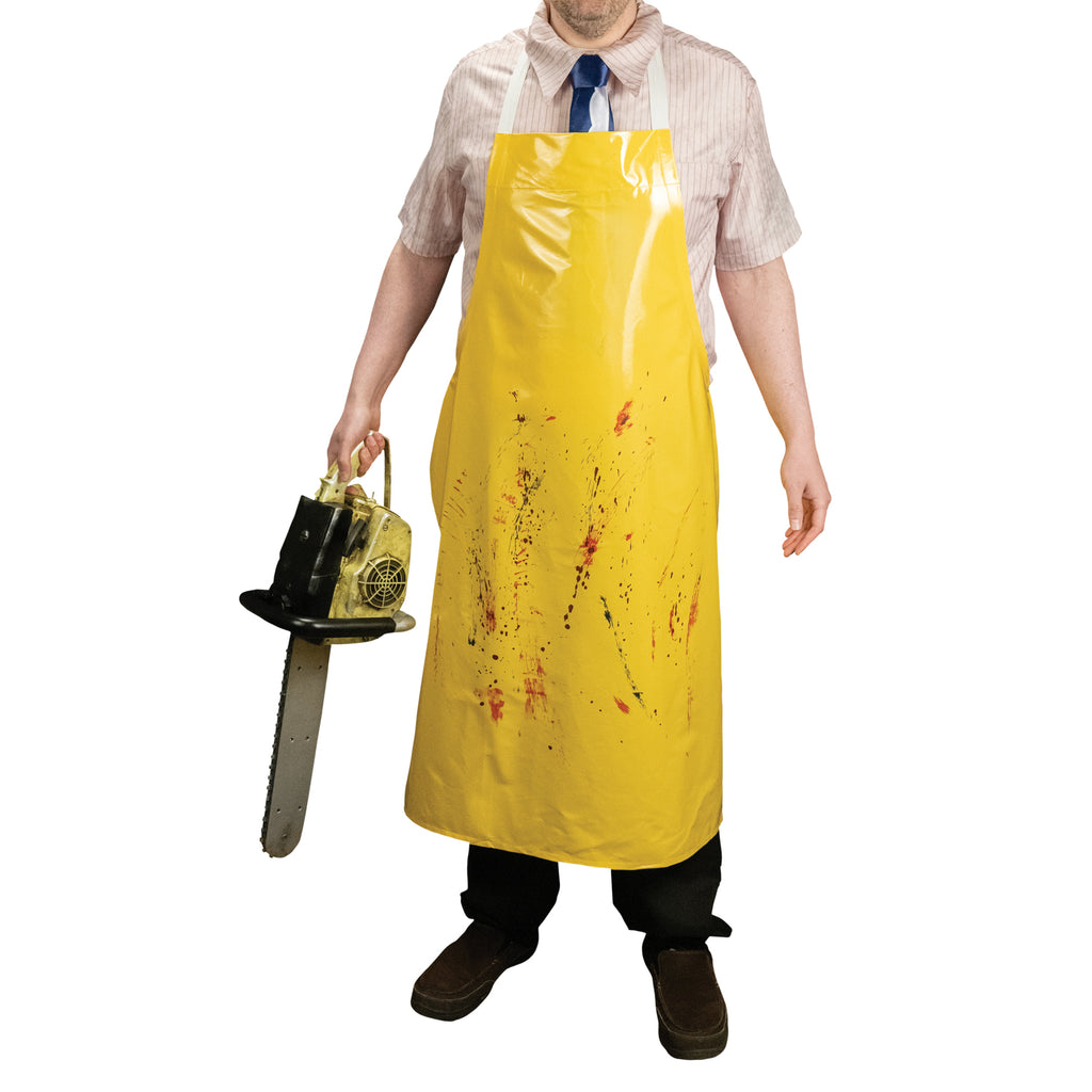 Man wearing yellow apron with faux blood splatter details holding chainsaw