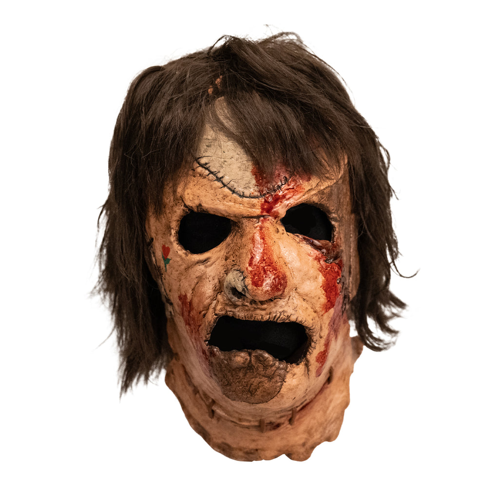 Leatherface latex mask with hair and faux blood splatter, front view