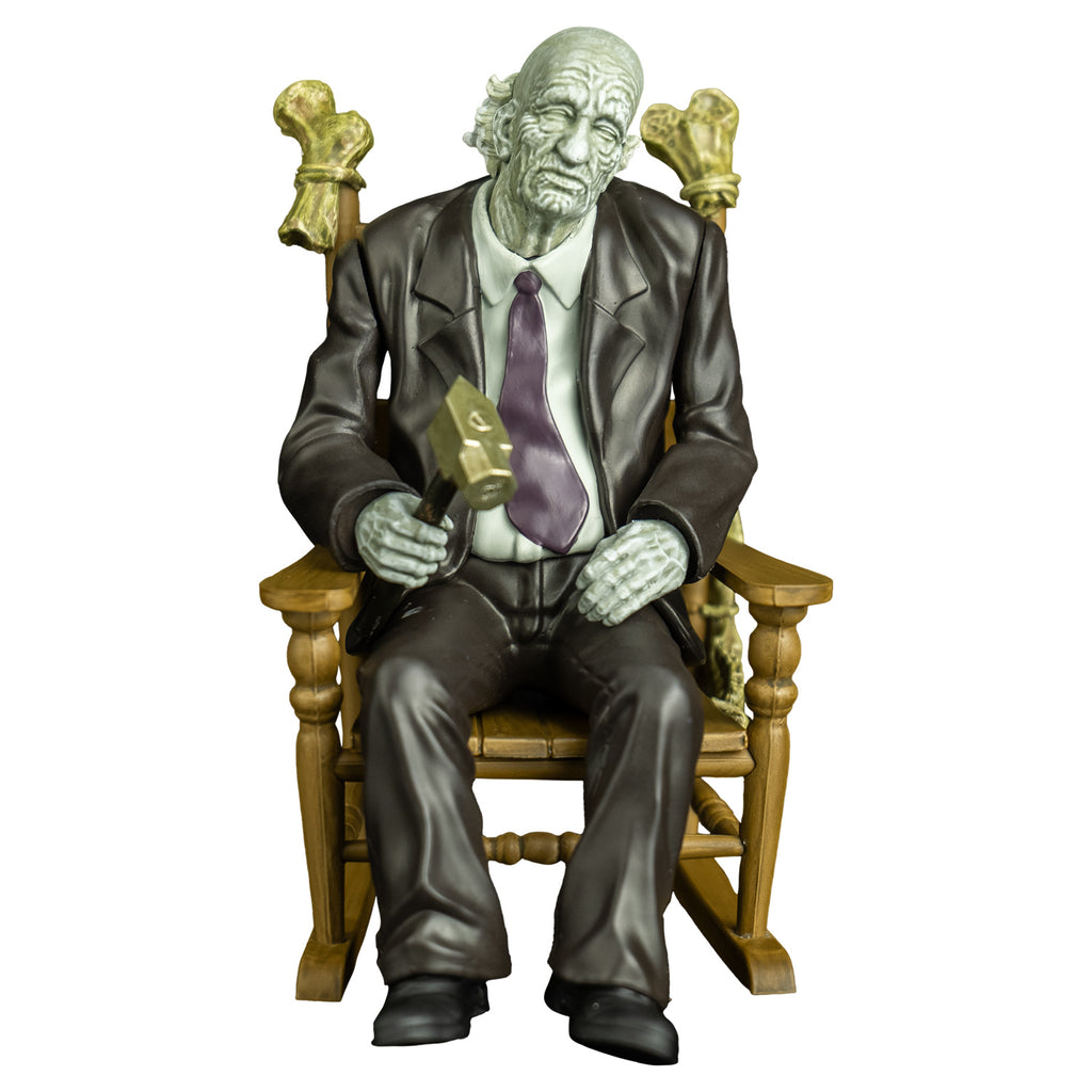 Grandpa figure, front view. old man, gray skin, bald, gray skin, wearing a suit and tie, holding a hammer in right hand, sitting in rocking chair with bones tied to the back, 