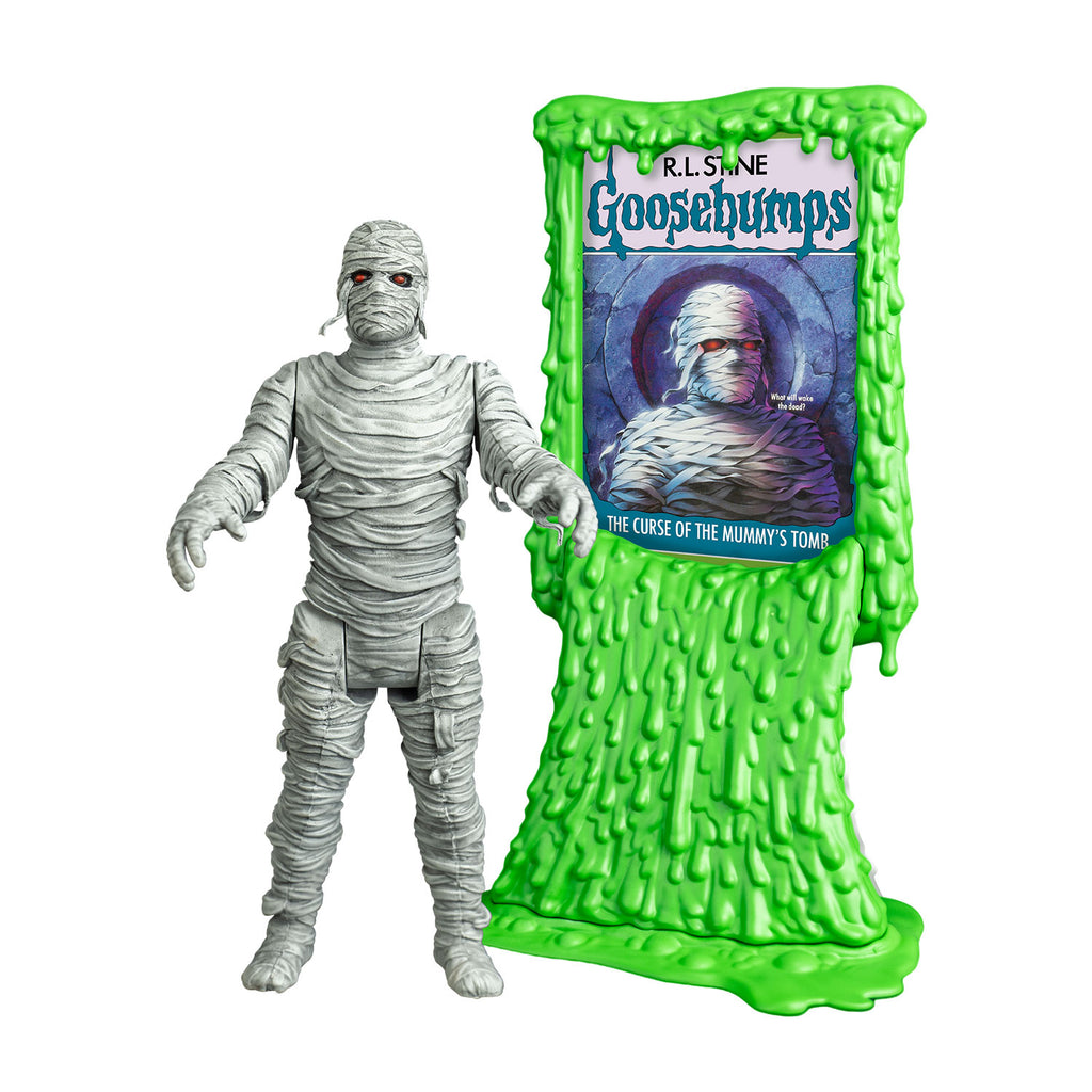 Mummy figure, front view. white bandaged head red eyes, black eye sockets. Black on tip of nose. body fully wrapped in white bandages.  arms outstretched to the front. shown next to Green slime book card stand